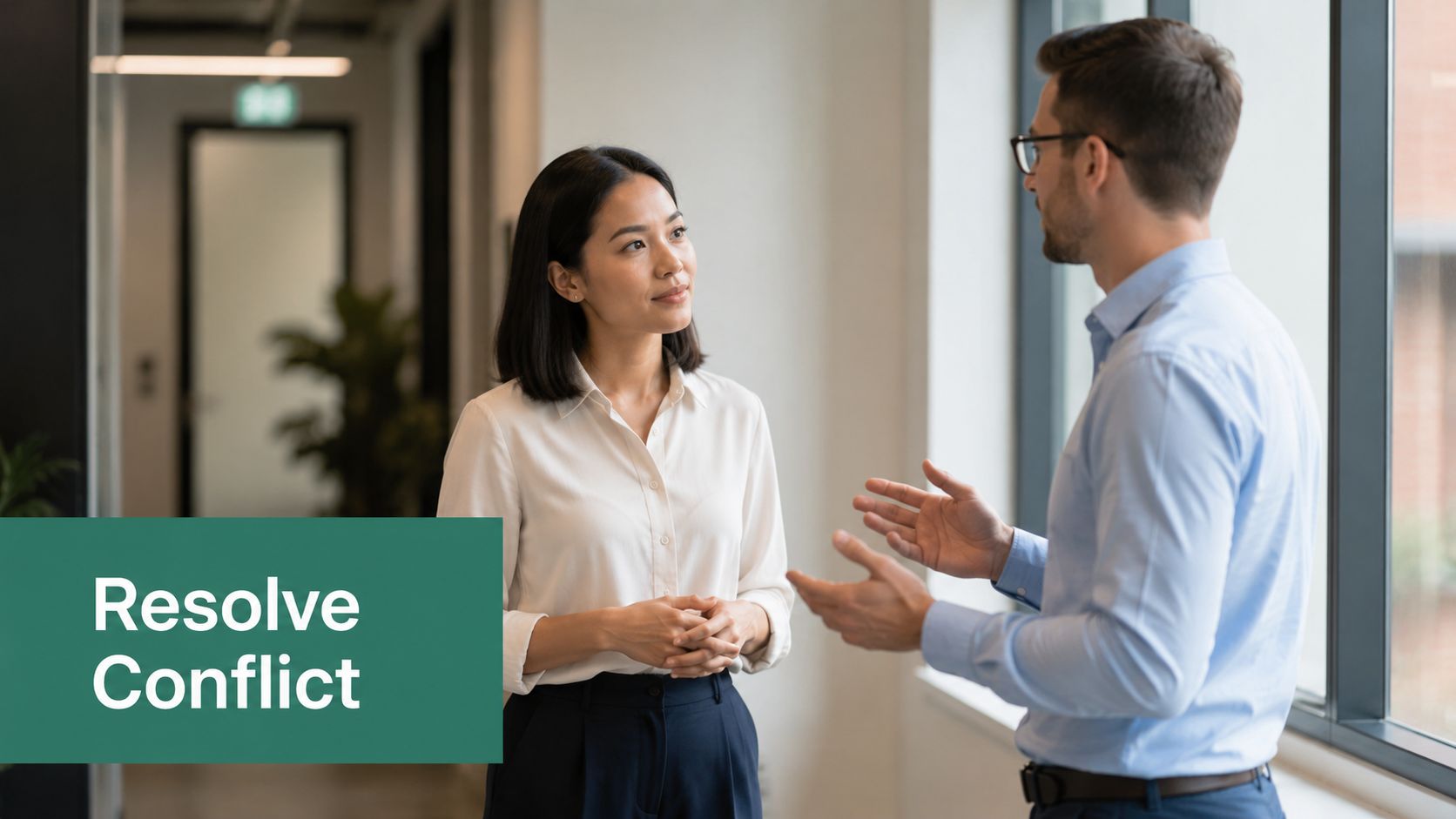 A professional woman and a man in business attire having a discussion about conflict resolution in office.